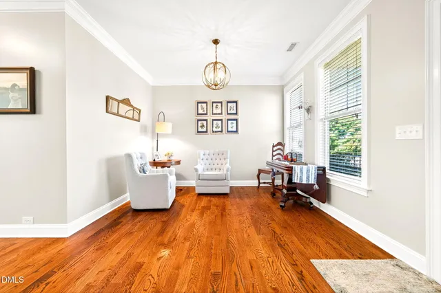 a bedroom with furniture and a chandelier