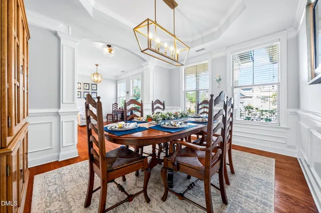 a view of a dining room with furniture and chandelier