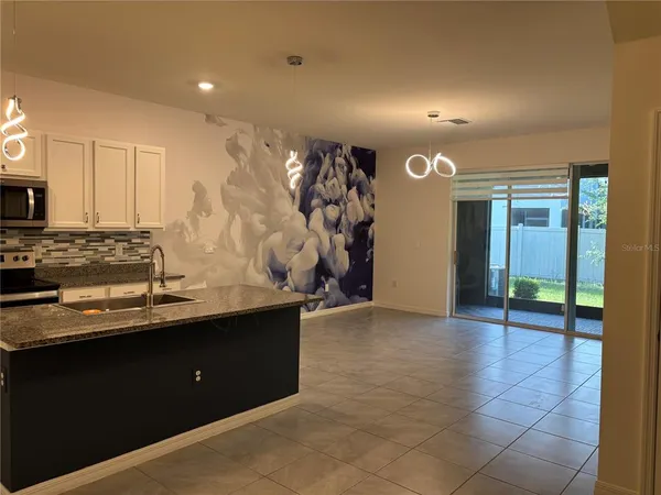 a kitchen with stainless steel appliances granite countertop a sink and cabinets