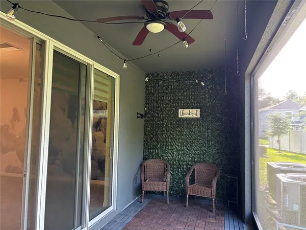 a view of a porch with a table and chairs