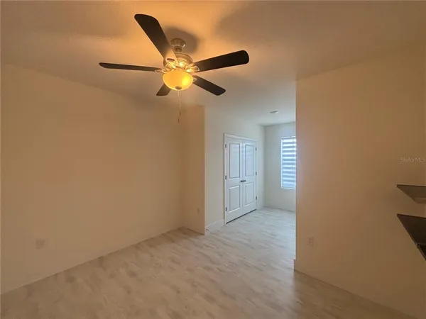 a view of a livingroom with a chandelier fan