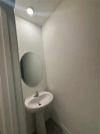 a white toilet sitting next to a white wall