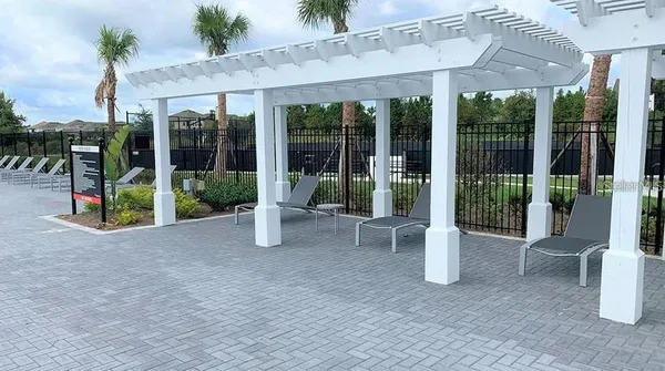 a view of a building with porch and chairs