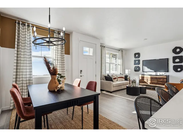 a living room with furniture a dining table and chairs