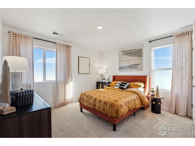 a bedroom with a bed and table