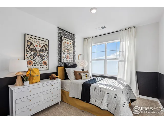 a bedroom with a bed and window with lamp