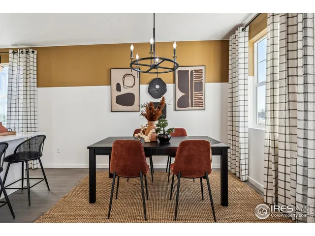 a view of a dining room with furniture and chandelier