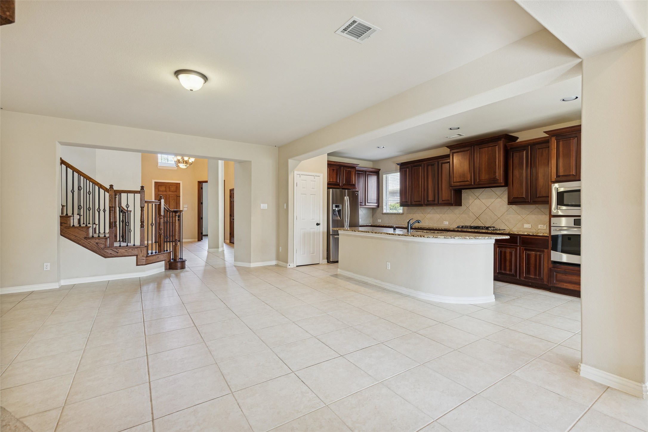 11 Vershire Circle Magnolia, TX 77354 - Photo 13 of 44 a large white building with kitchen island granite countertop a sink cabinets and stainless steel appliances