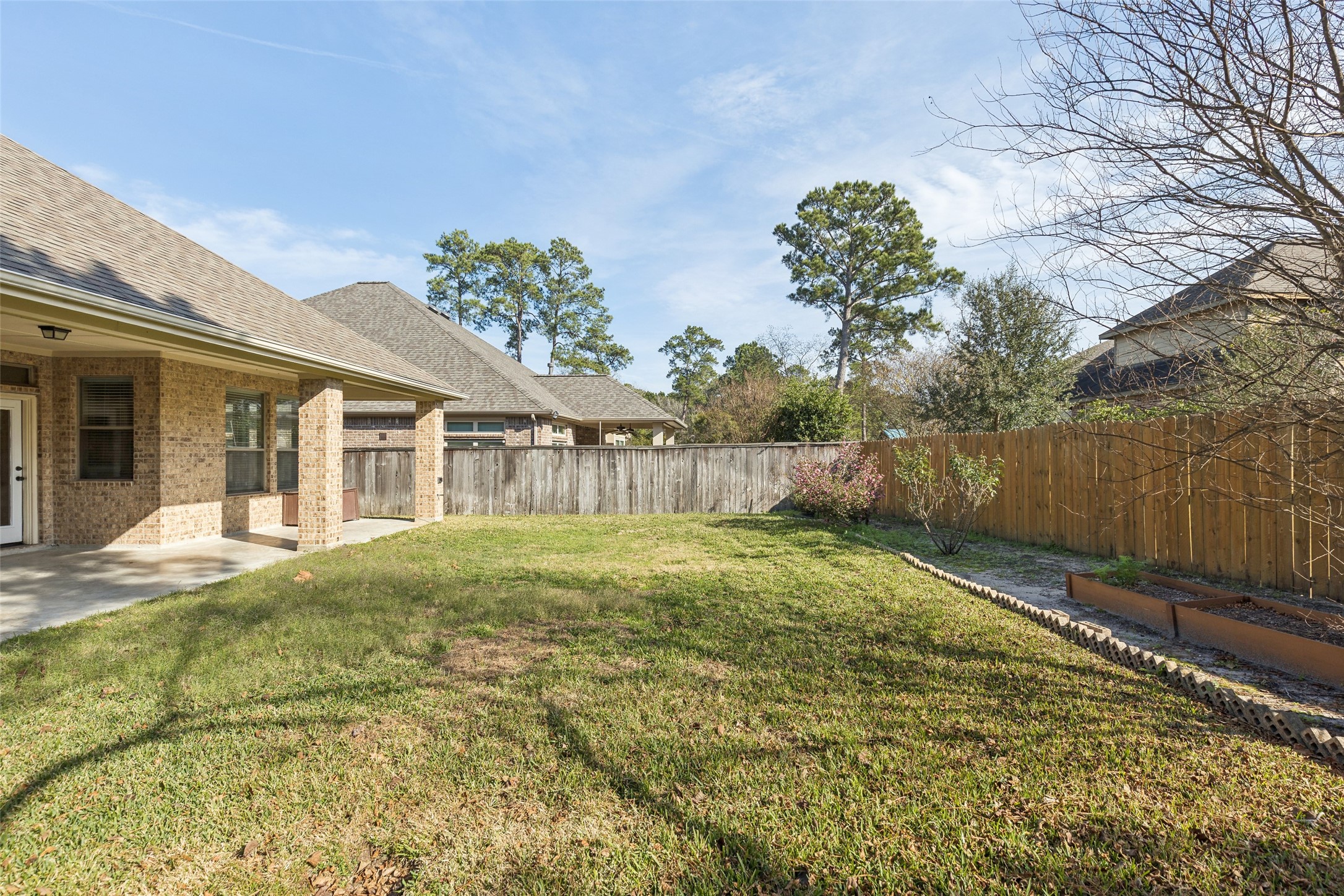 11 Vershire Circle Magnolia, TX 77354 - Photo 40 of 44 a view of a house with a backyard and a garden
