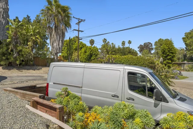a view of a balcony with potted plants