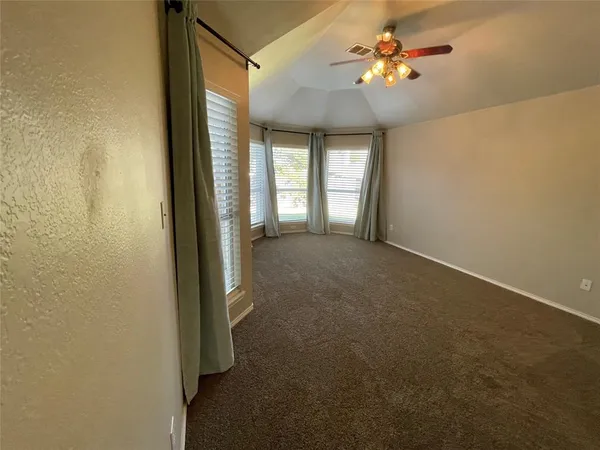 a view of n empty room with a window