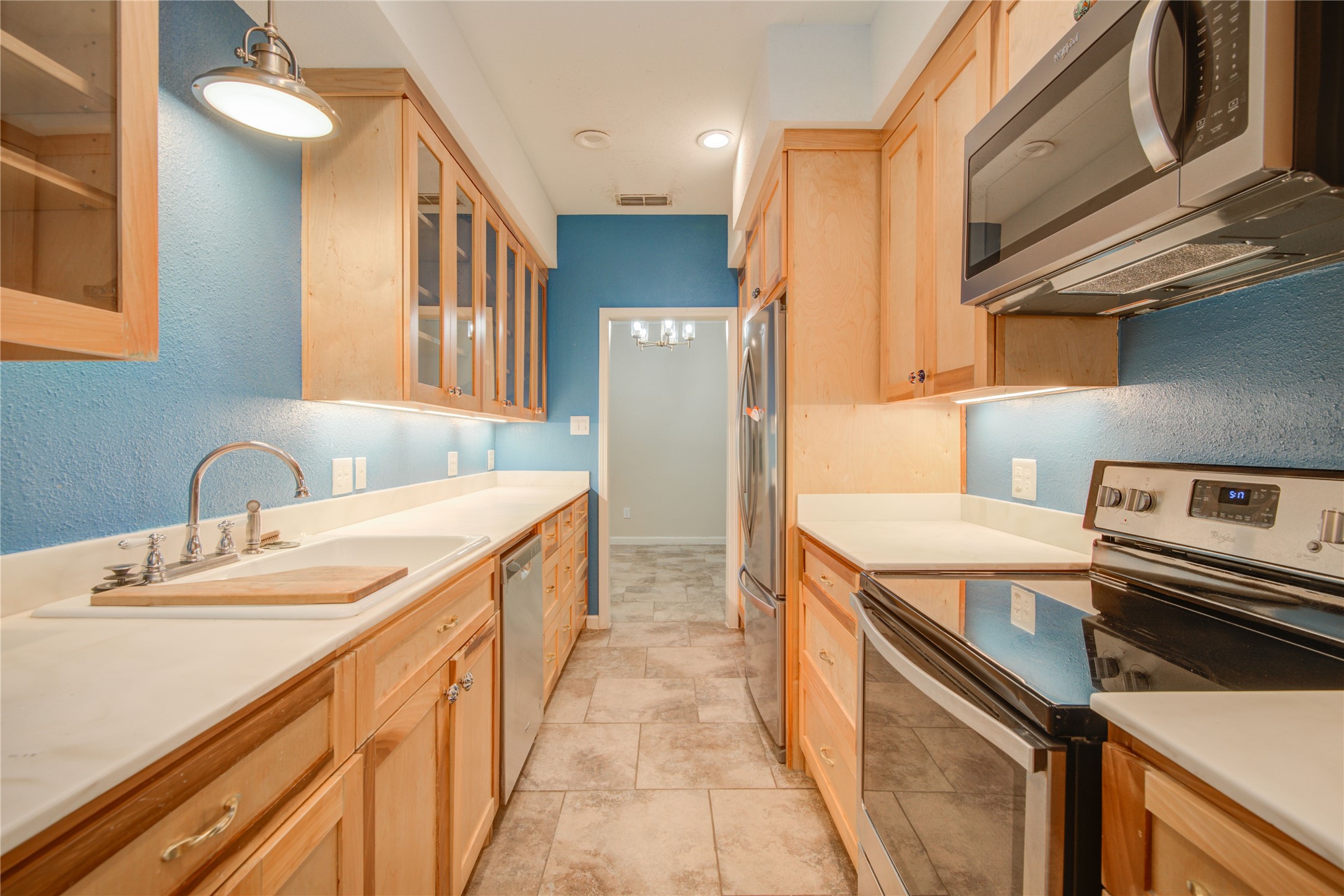 7449 Brompton Street, Unit 7449 Houston, TX 77025 - Photo 14 of 46 Kitchen has plenty of countertop space, custom glass front cabinetry, & SS appliances stay