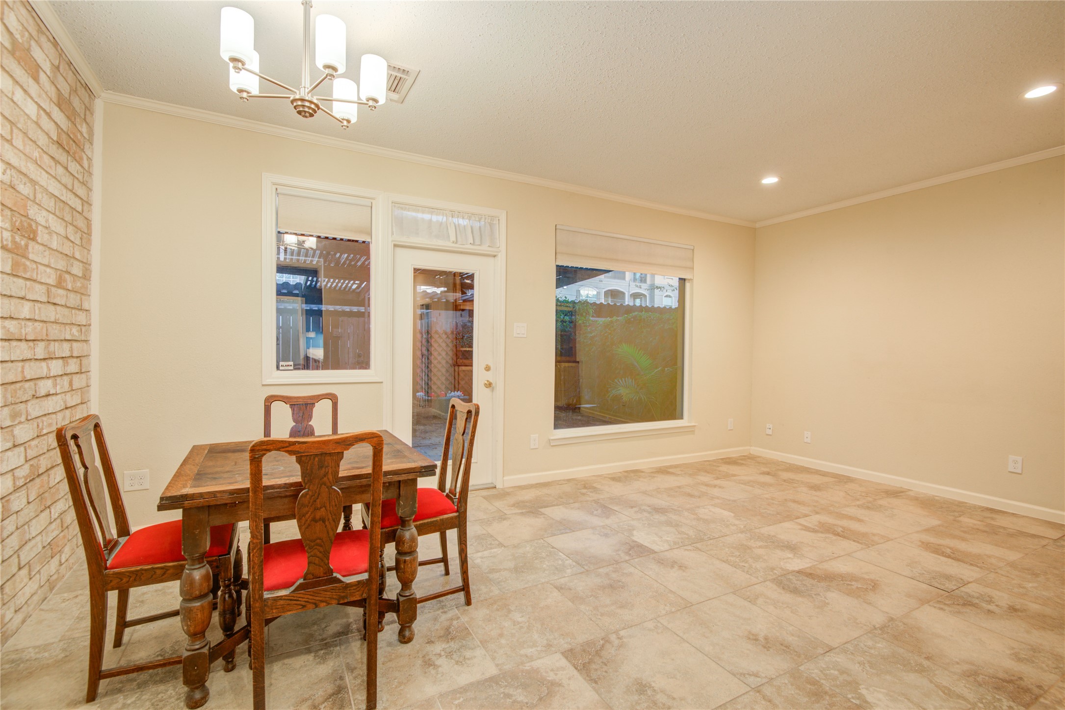 7449 Brompton Street, Unit 7449 Houston, TX 77025 - Photo 16 of 46 a view of a dining room with furniture and chandelier