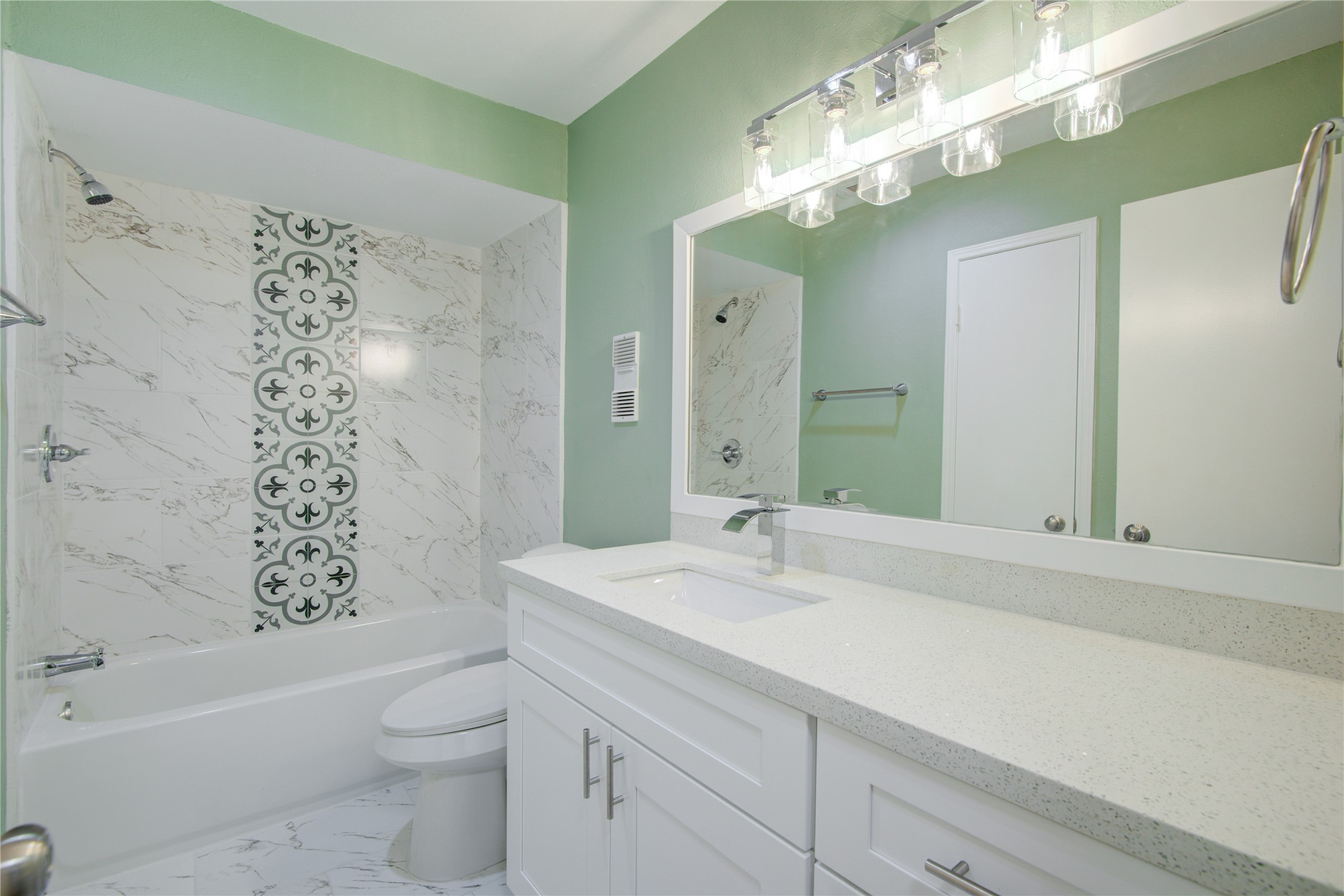7449 Brompton Street, Unit 7449 Houston, TX 77025 - Photo 24 of 46 a bathroom with a sink a toilet a mirror a vanity a bathtub and shower