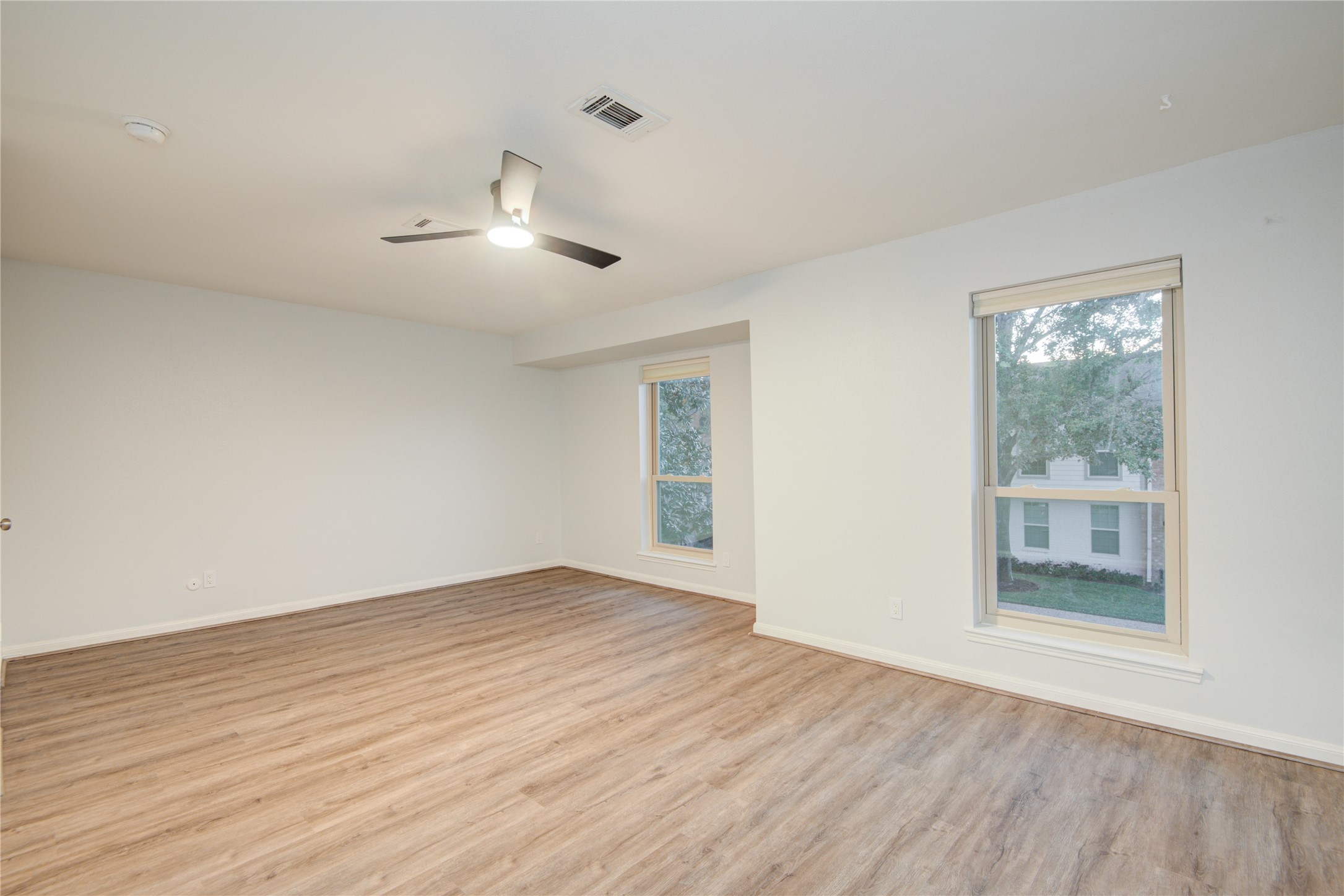 7449 Brompton Street, Unit 7449 Houston, TX 77025 - Photo 27 of 46 wooden floor in an empty room with a window