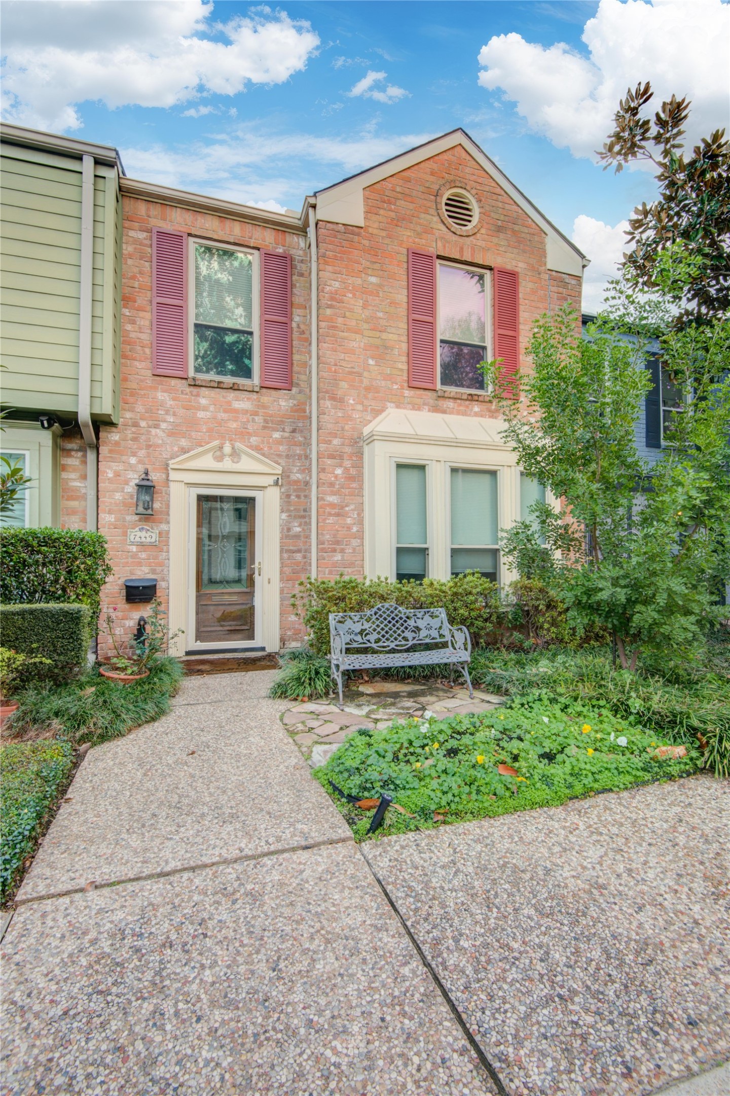 7449 Brompton Street, Unit 7449 Houston, TX 77025 - Photo 3 of 46 a front view of a house with a yard and garage
