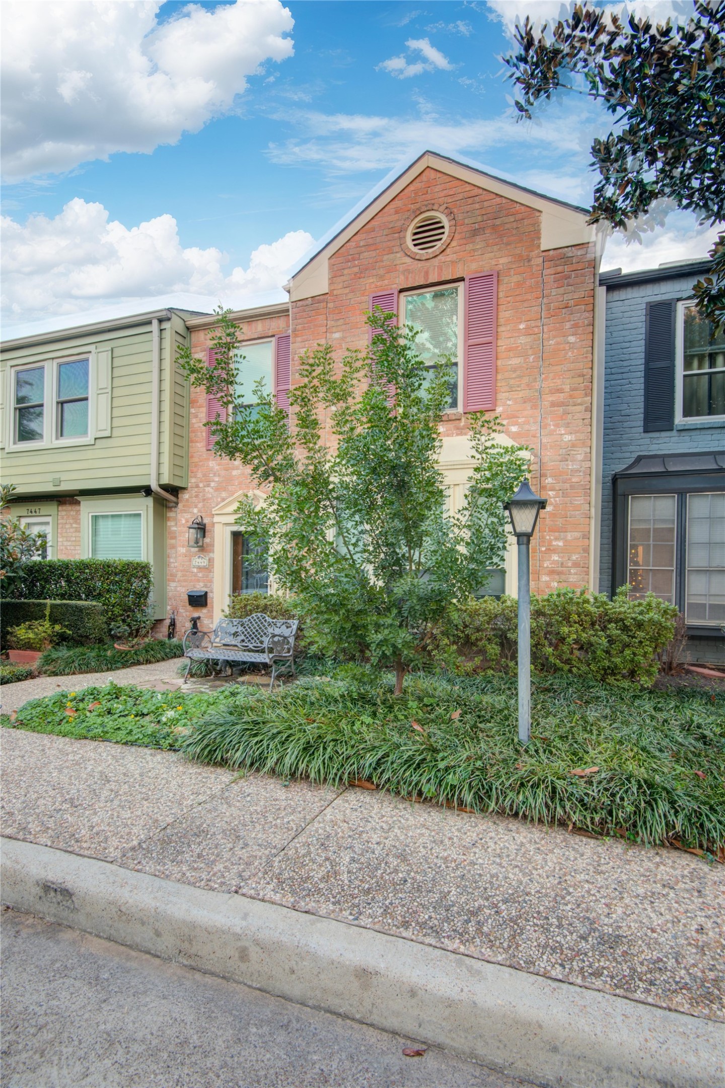 7449 Brompton Street, Unit 7449 Houston, TX 77025 - Photo 4 of 46 a front view of a house with a yard and a garage