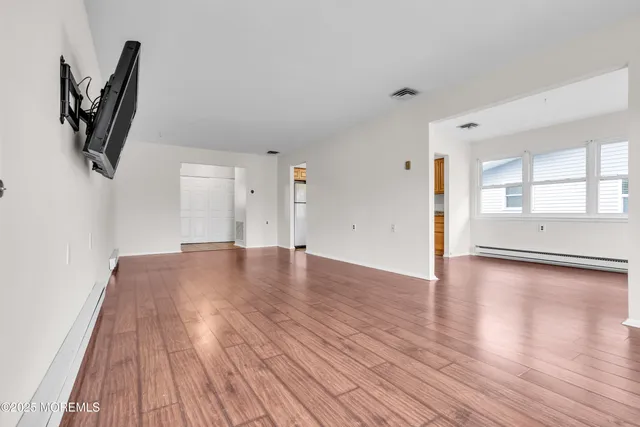 a view of a livingroom with wooden floor and closet