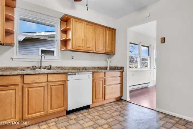 a kitchen with granite countertop white cabinets and white appliances