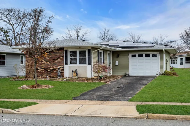 a front view of a house with a yard garage and outdoor seating