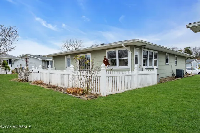 a view of a yard with wooden fence
