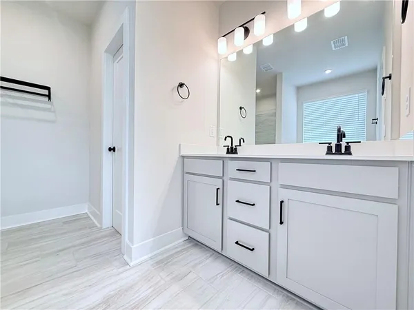 a room with white cabinets and sink