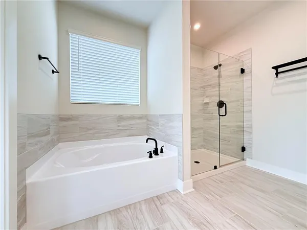 a bathroom with a bathtub and a shower