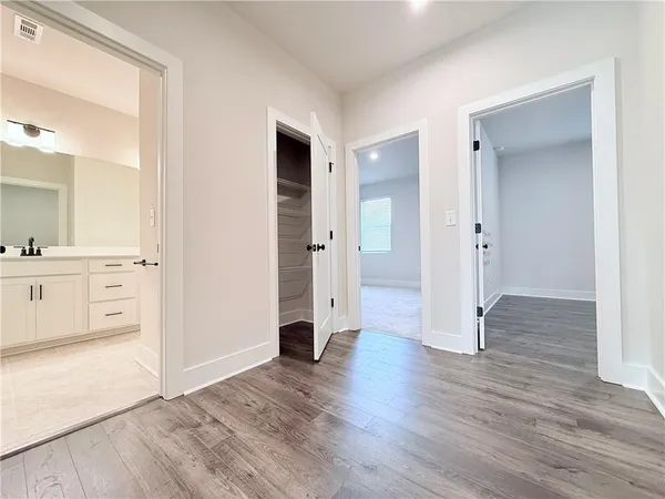 an empty room with wooden floor and cabinet