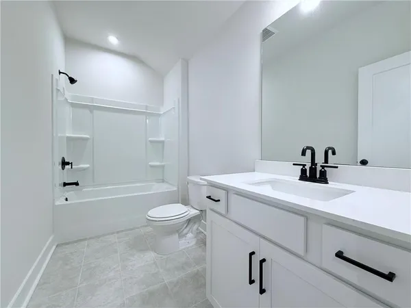 a bathroom with a sink a toilet and a tub