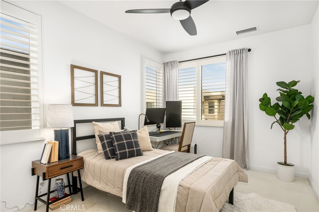 186 Terrapin Irvine, CA 92618 - Photo 16 of 39 a bedroom with a bed a chandelier and window