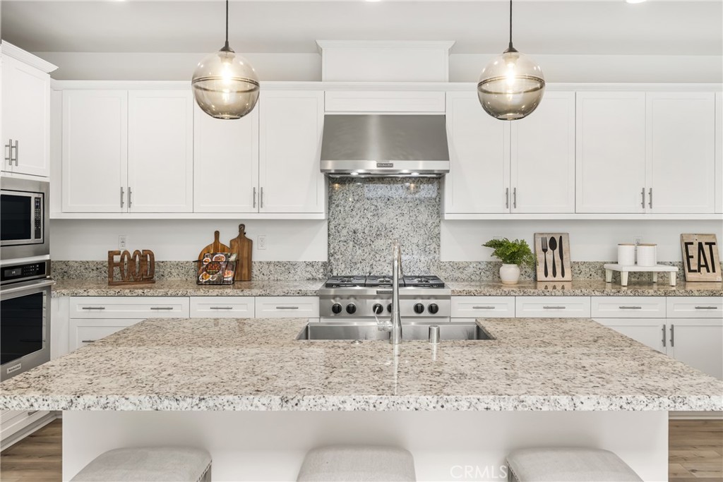 186 Terrapin Irvine, CA 92618 - Photo 9 of 39 a kitchen with stainless steel appliances granite countertop a sink a stove counter space and cabinets