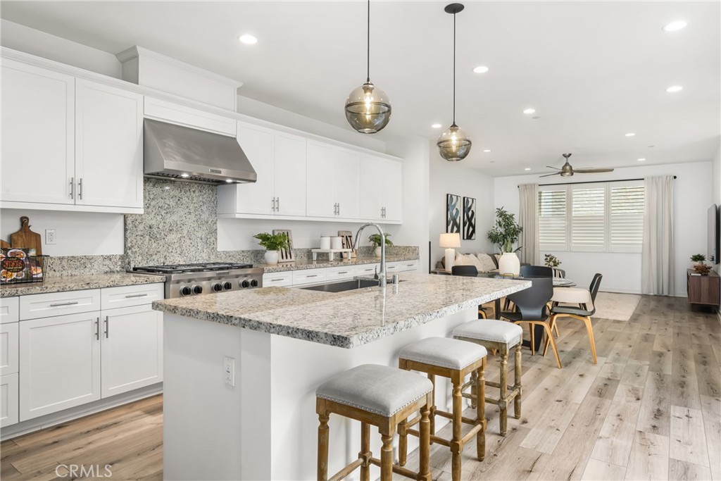 186 Terrapin Irvine, CA 92618 - Photo 10 of 39 a kitchen with stainless steel appliances granite countertop a stove a sink a dining table chairs and view living room