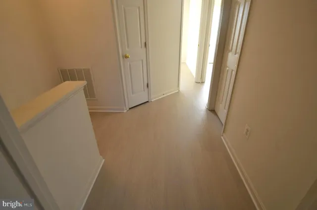a view of a room with wooden floor