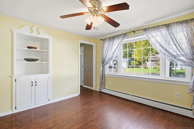 wooden floor in an empty room with a window