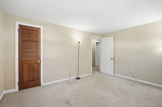 an empty room with closet area