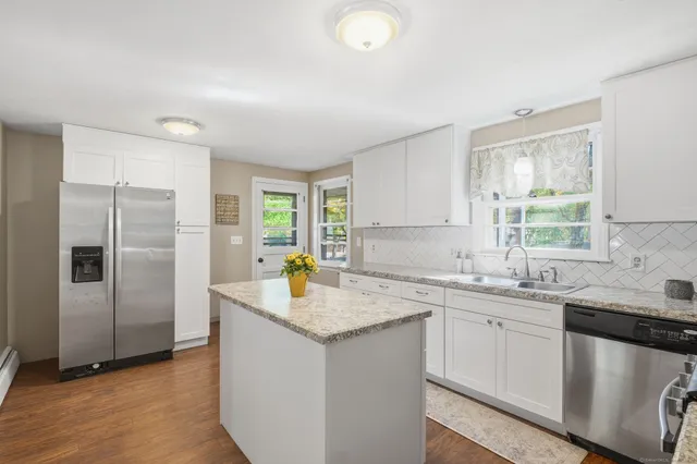 a kitchen with a sink a refrigerator and window
