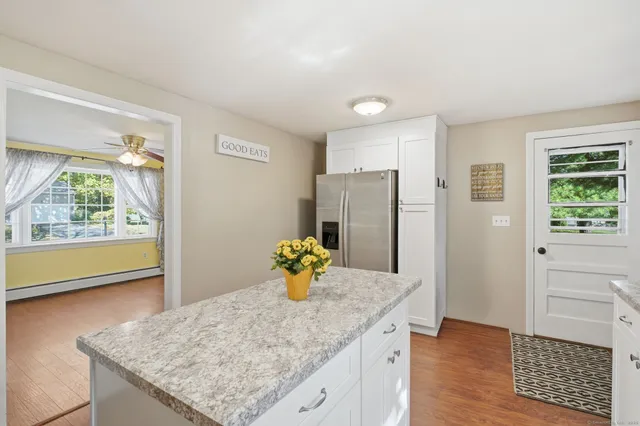 a kitchen with stainless steel appliances granite countertop a refrigerator and a sink
