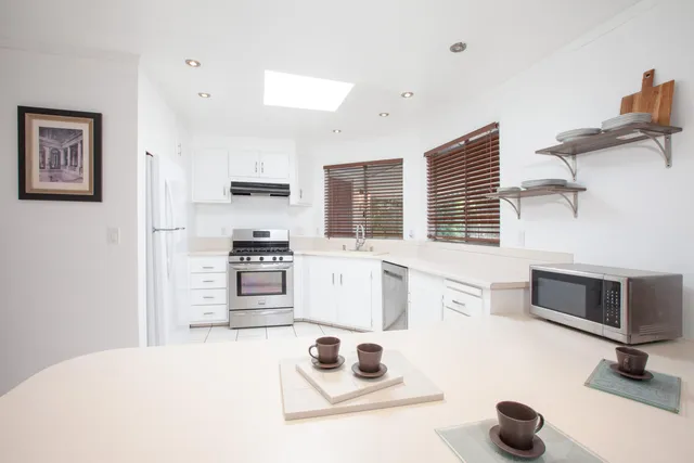 a kitchen with stainless steel appliances kitchen island a stove and a refrigerator