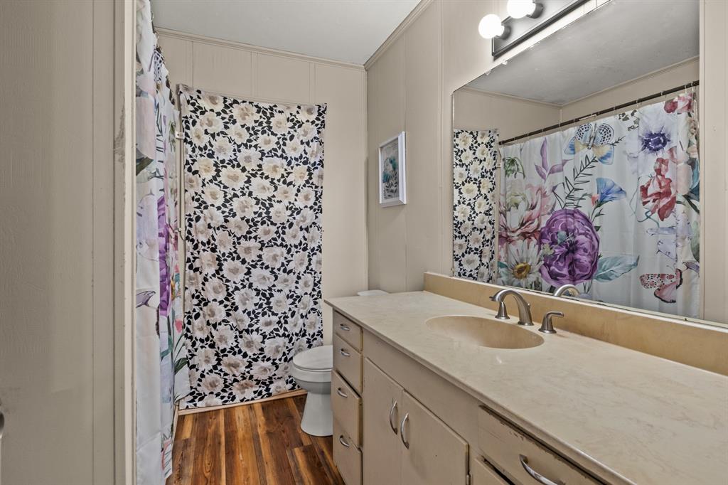 1210 East 4th Street Mount Pleasant, TX 75455 - Photo 13 of 28 a bathroom with a sink toilet and shower