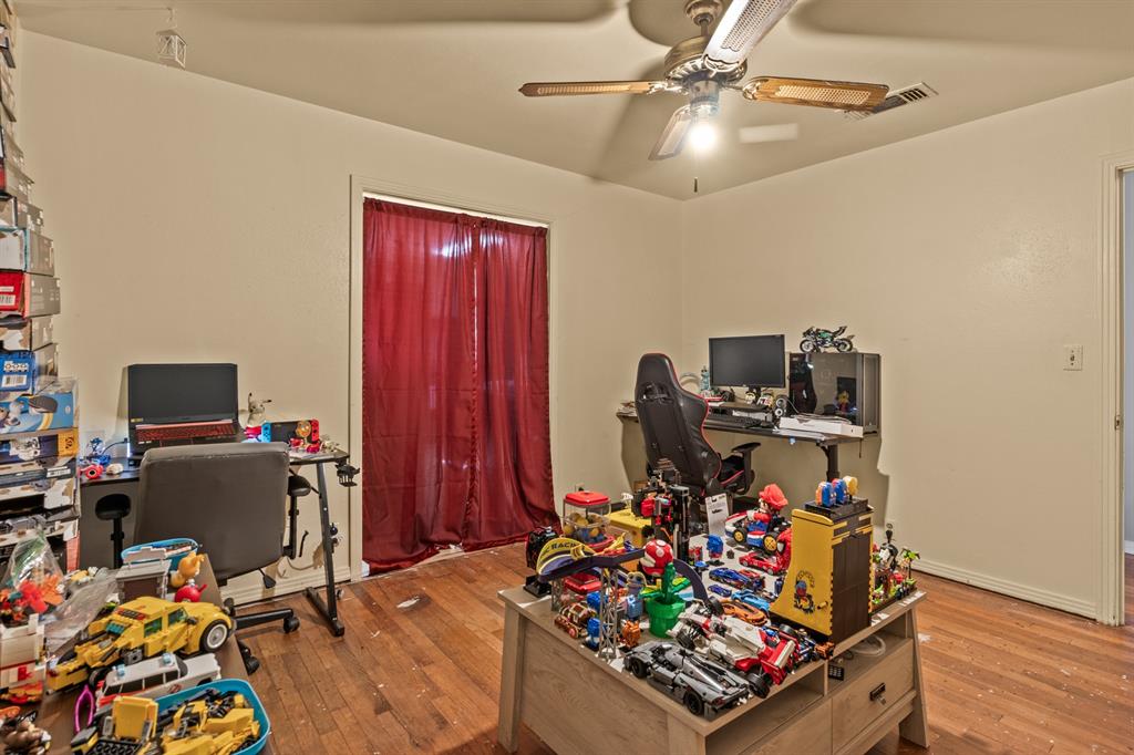 1210 East 4th Street Mount Pleasant, TX 75455 - Photo 15 of 28 a view of a workspace with furniture and a window