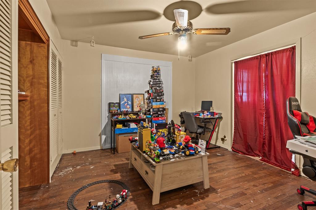 1210 East 4th Street Mount Pleasant, TX 75455 - Photo 16 of 28 a living room with furniture and a chandelier