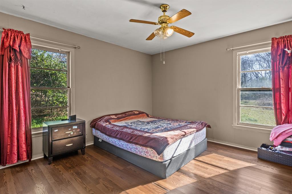 1210 East 4th Street Mount Pleasant, TX 75455 - Photo 18 of 28 a bedroom with a bed a couch and a window