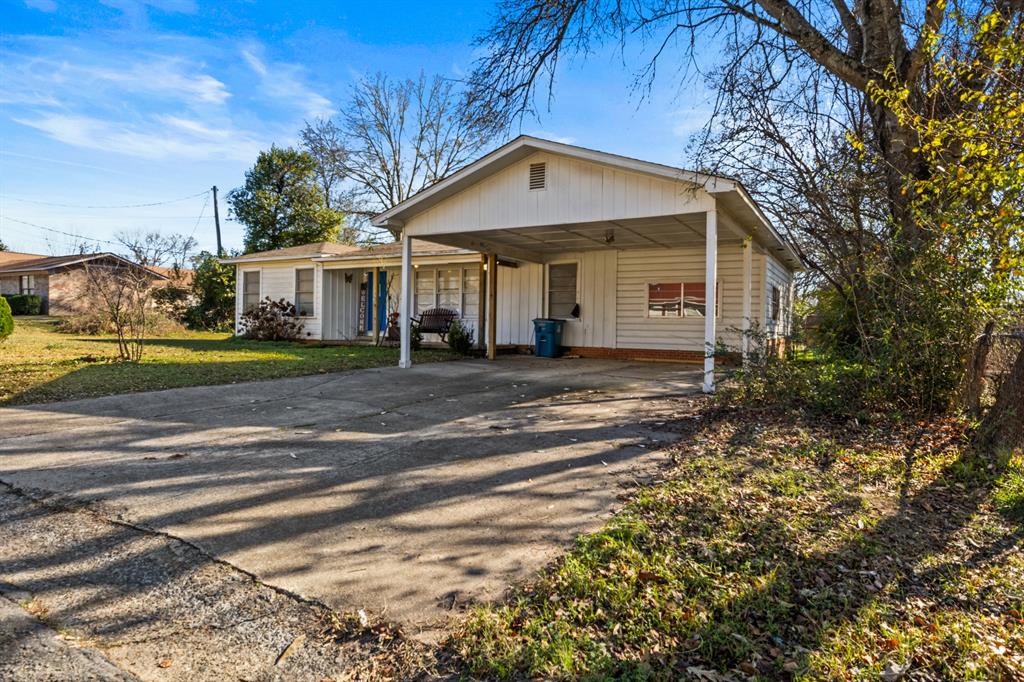 1210 East 4th Street Mount Pleasant, TX 75455 - Photo 2 of 28 a front view of a house with a yard