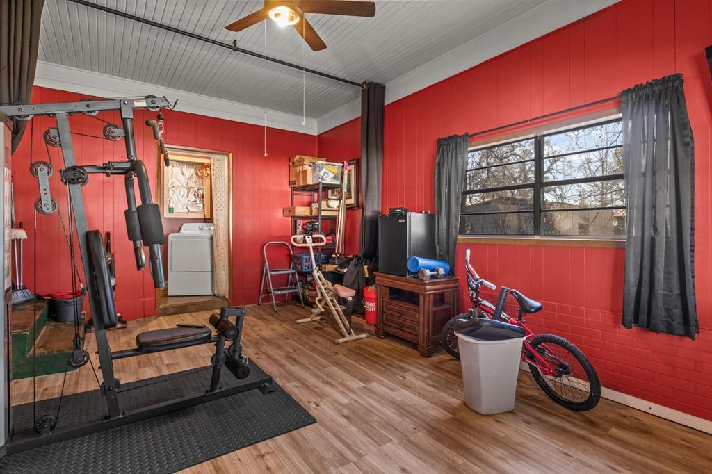 1210 East 4th Street Mount Pleasant, TX 75455 - Photo 21 of 28 a living room with furniture a flat screen tv and a window
