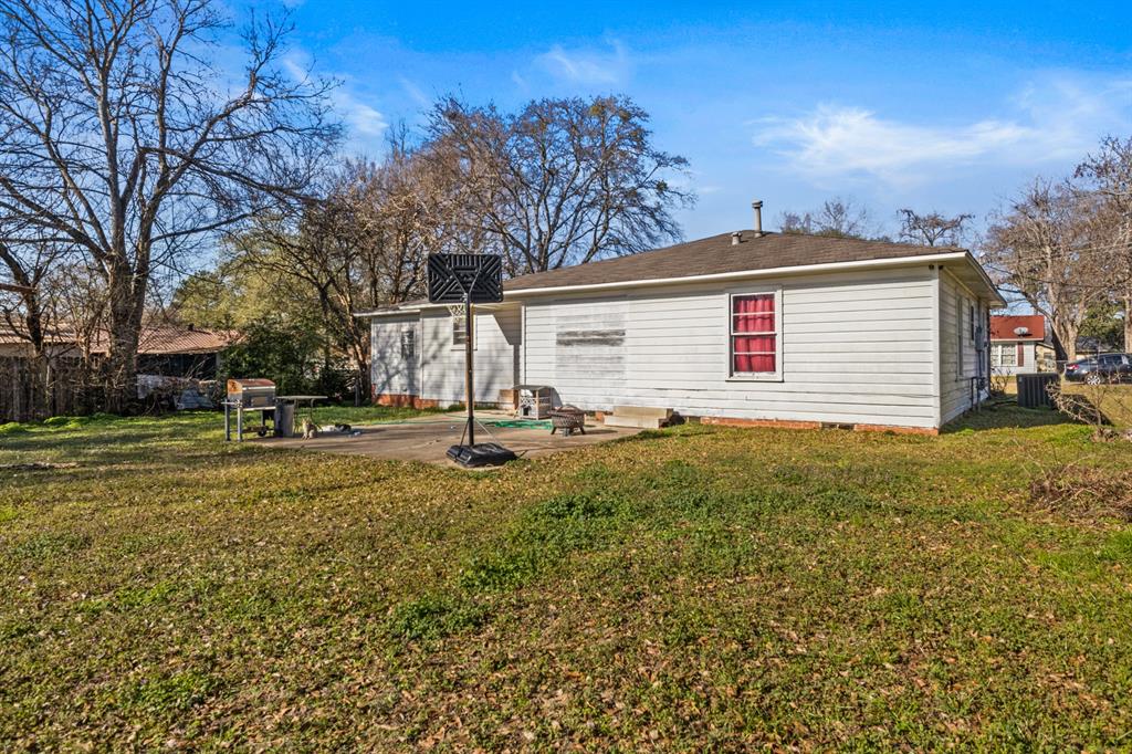 1210 East 4th Street Mount Pleasant, TX 75455 - Photo 23 of 28 a view of a house with a yard