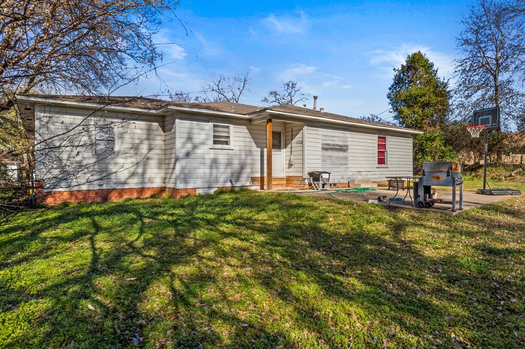 1210 East 4th Street Mount Pleasant, TX 75455 - Photo 26 of 28 a view of a house with a yard