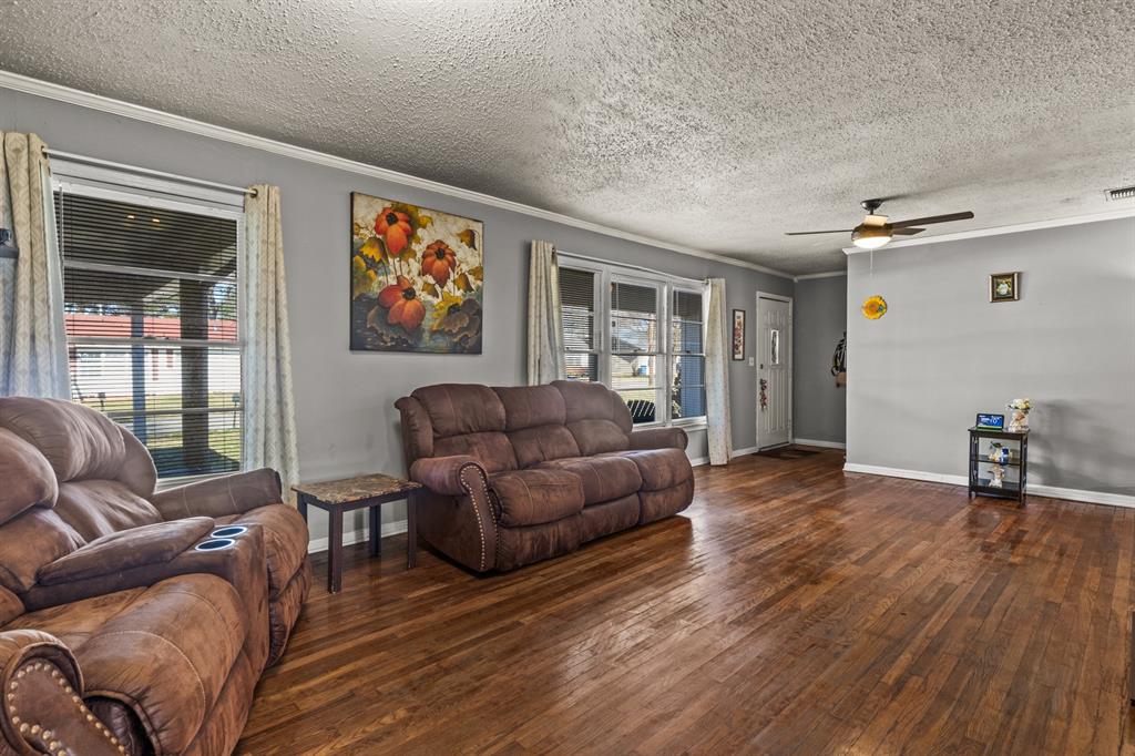 1210 East 4th Street Mount Pleasant, TX 75455 - Photo 5 of 28 a living room with furniture and a wooden floor