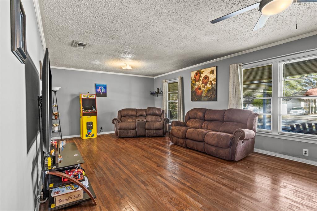 1210 East 4th Street Mount Pleasant, TX 75455 - Photo 6 of 28 a living room with furniture a flat screen tv and a large window