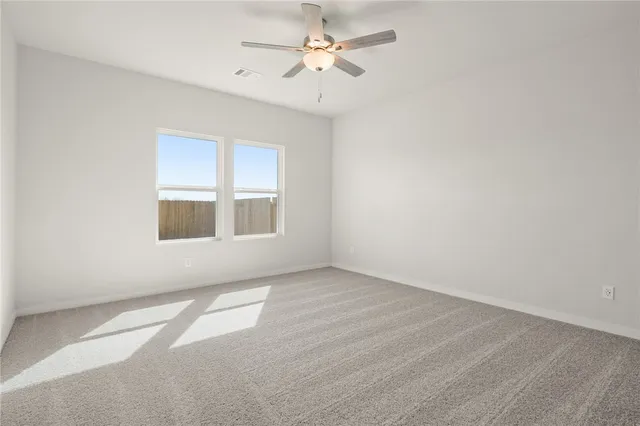 a view of a kitchen with white cabinets and wooden floor