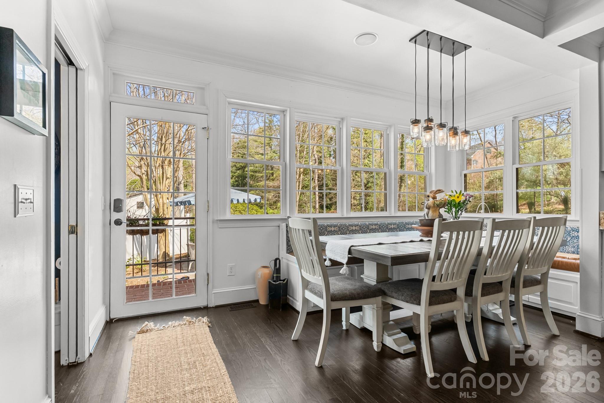 211 Dutchman Creek Road Elkin, NC 28621 - Photo 19 of 48 a view of a dining room with furniture wooden floor and chandelier